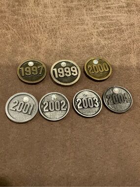 Set of 7 Year Tokens from a Plaque